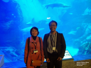 A man and a woman before a giant aquarium